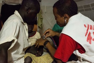 MSF doctor vaccinating child in global public health initiative